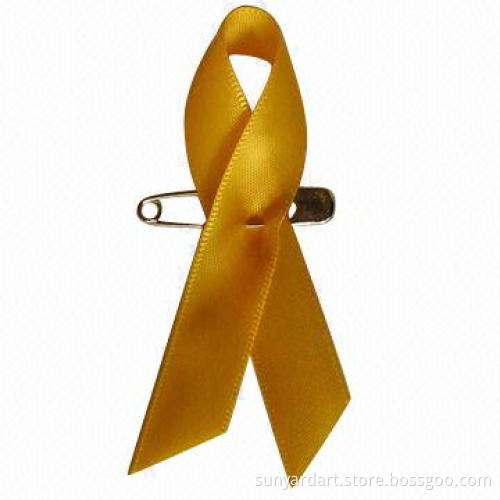 Cancer awareness ribbon bow with safety pin